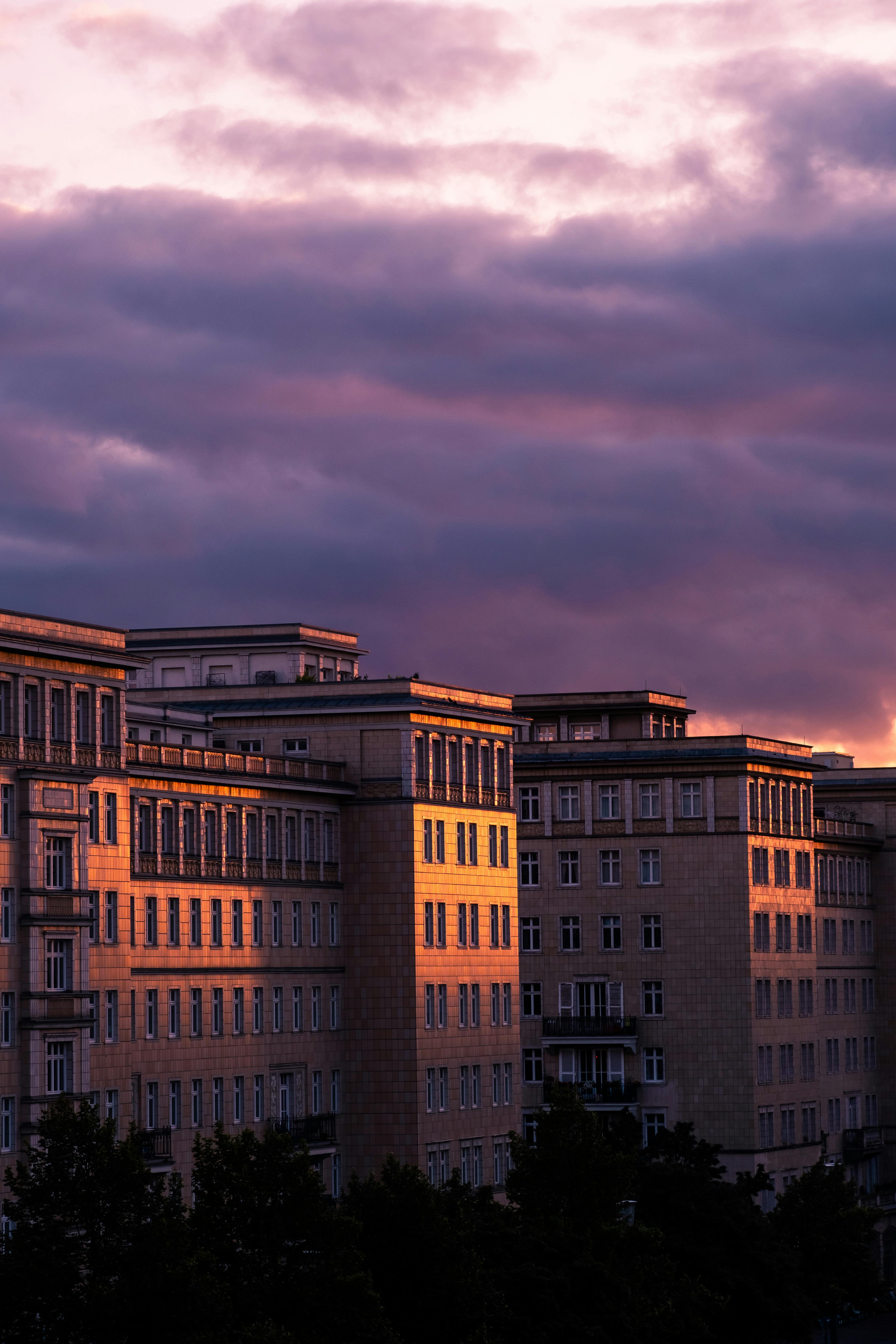 Beautiful sunset casting dramatic light on Berlin buildings with a cloudy sky backdrop.