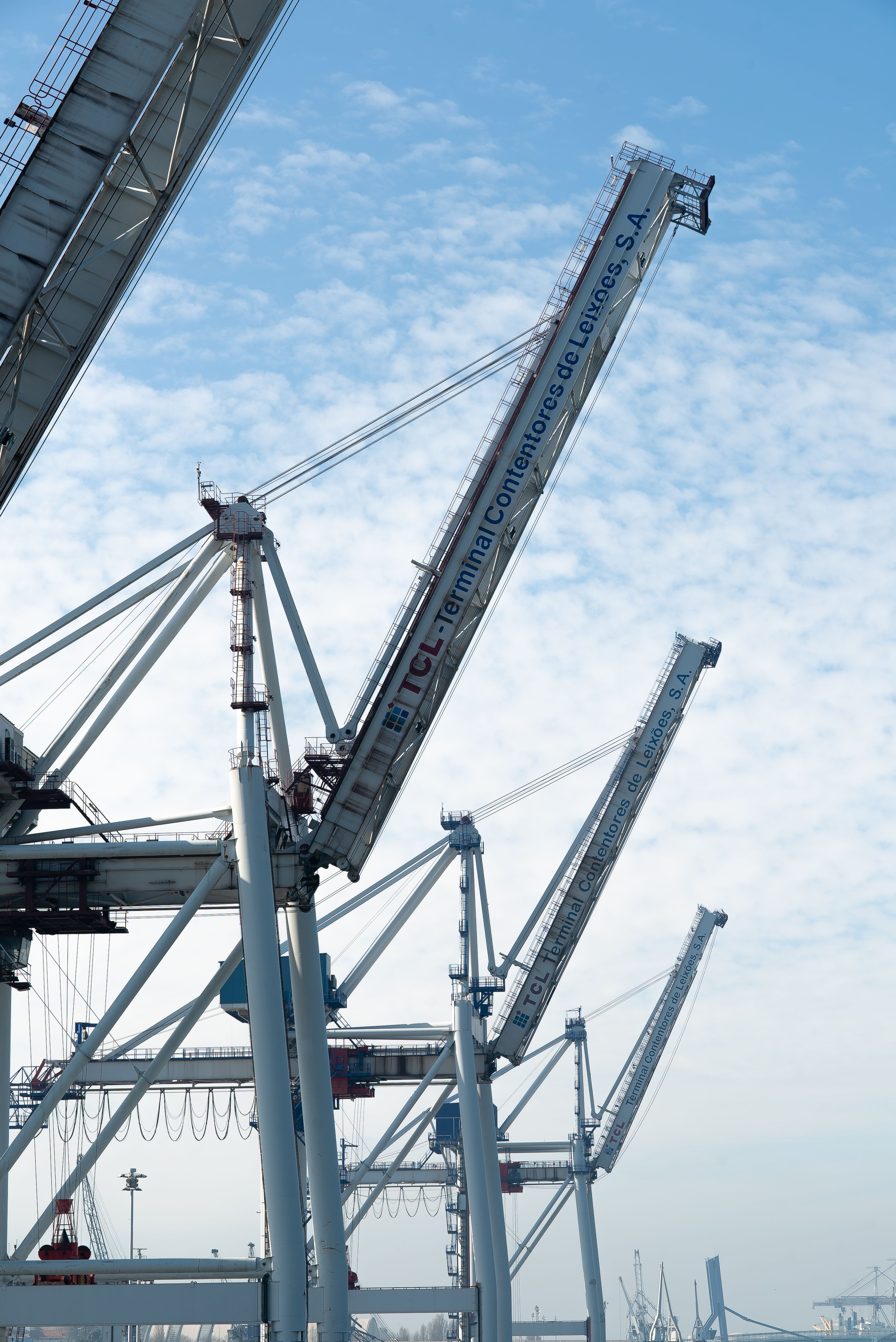 Vertical shot of industrial cranes at Porto harbor, epitomizing efficiency and industry.