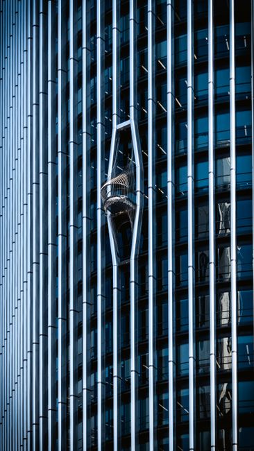 Reflective skyscraper in Madrid showcasing modern glass facade and architectural design.