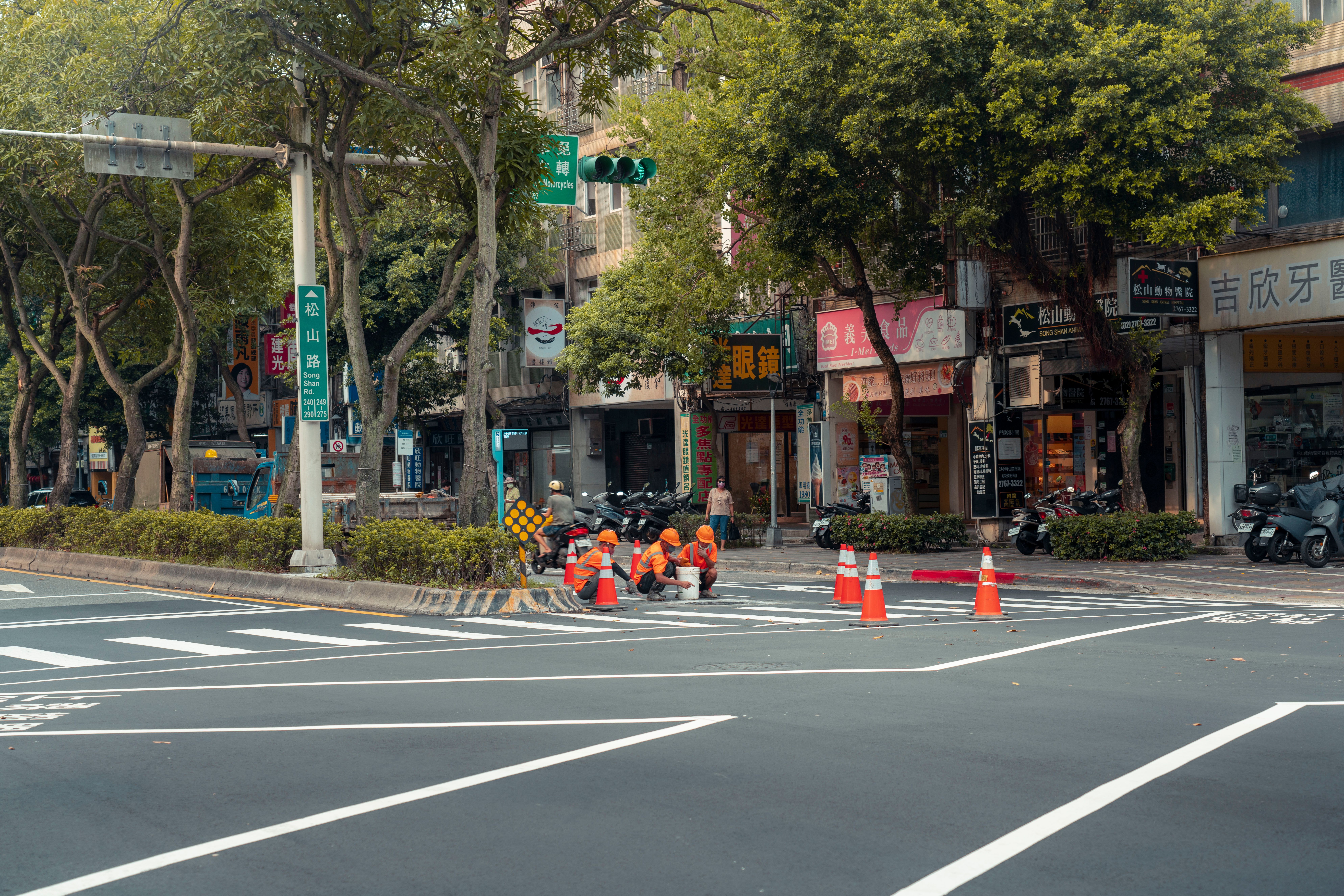Crew applying traffic markings and road striping on asphalt