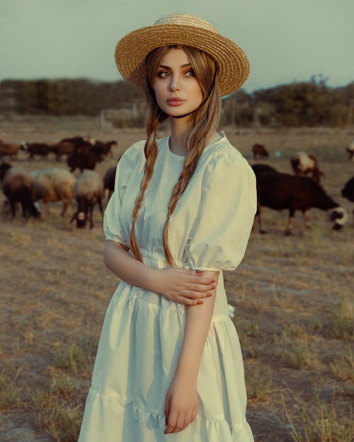 Beautiful Woman in White Dress on Pasture