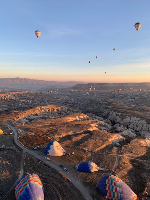 Free Stunning aerial view of hot air balloons floating above Cappadocia at sunrise. Stock Photo