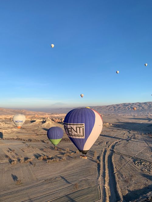 Free Breathtaking view of vibrant hot air balloons soaring over Cappadocia's unique landscape at sunrise. Stock Photo