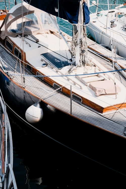 Free A close-up view of a luxurious yacht moored at a marina, showcasing a peaceful nautical setting. Stock Photo