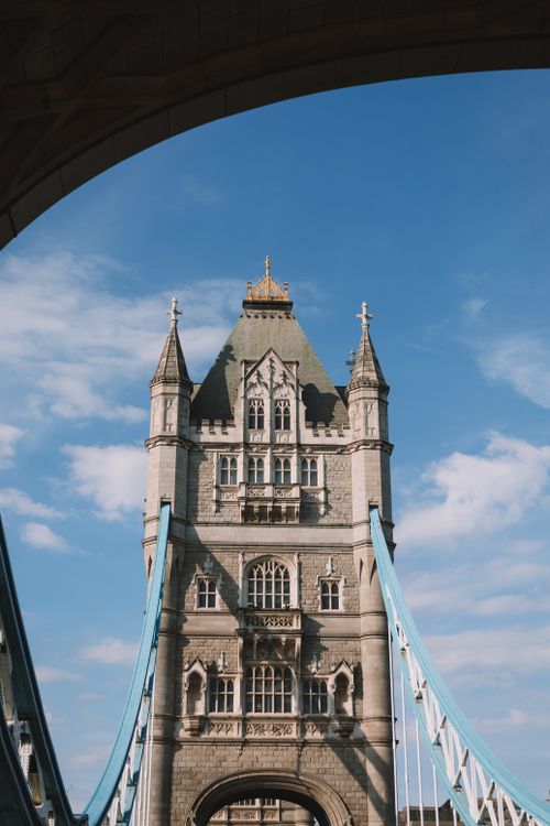 Free Vertical view of Tower Bridge in London with a clear blue sky, capturing architectural details. Stock Photo