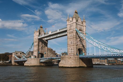 View of the iconic Tower Bridge spanning the River Thames in London, England on a sunny day.