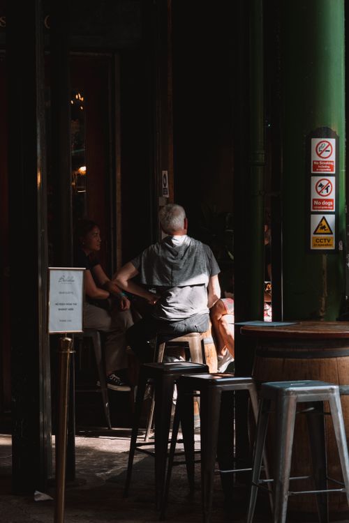 Free A relaxed atmosphere in a London pub with patrons enjoying the ambiance. Stock Photo