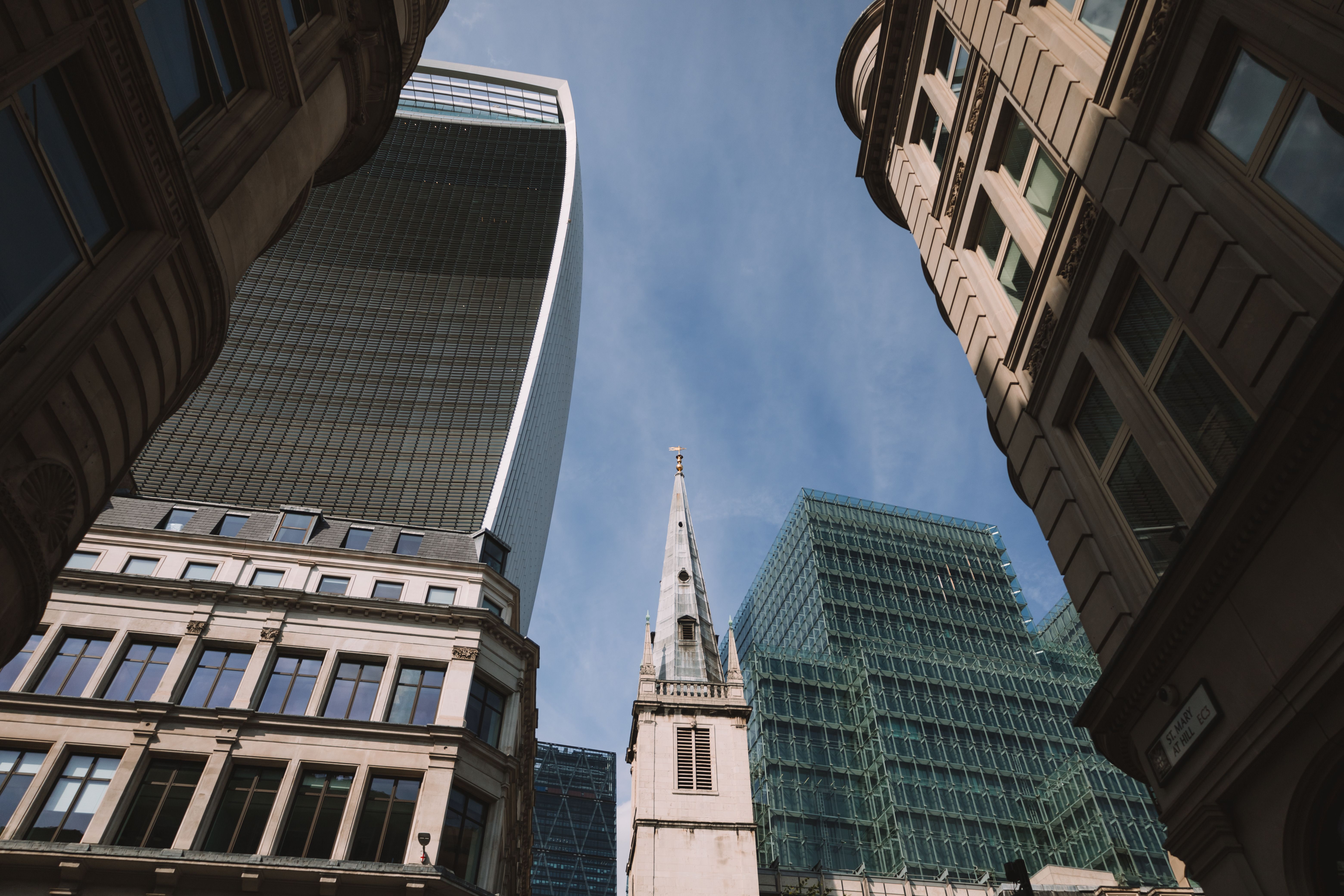Low-angle view of modern and historic skyscrapers in London.
