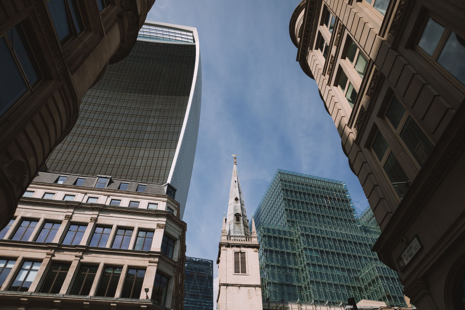 Low-angle view of modern and historic skyscrapers in London.