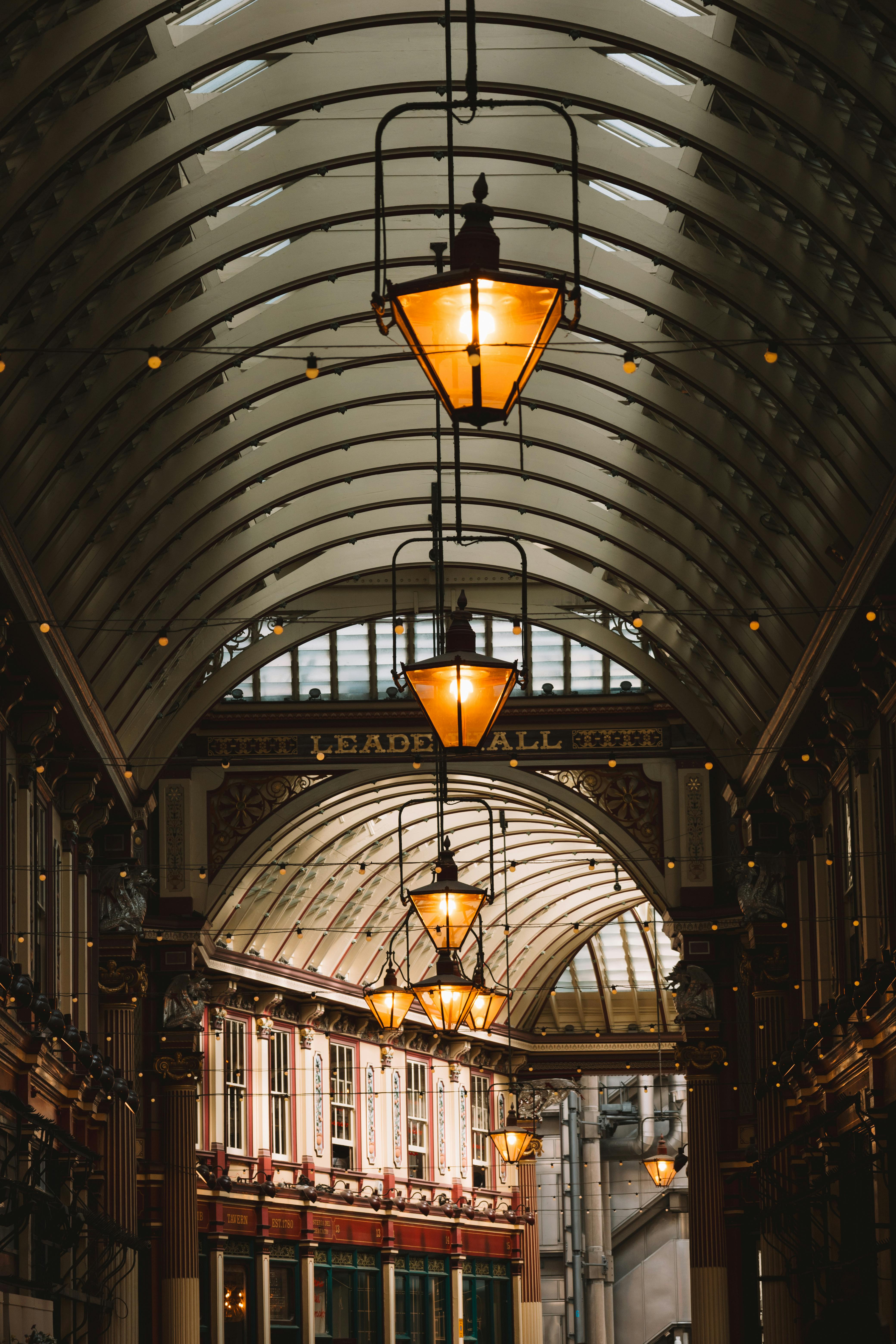 Beautiful interior view of Leadenhall Market in London, showcasing elegant architecture and vintage lamps.