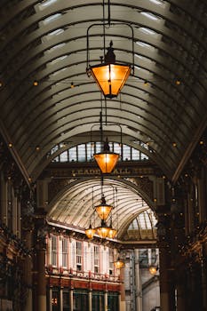 Beautiful interior view of Leadenhall Market in London, showcasing elegant architecture and vintage lamps.
