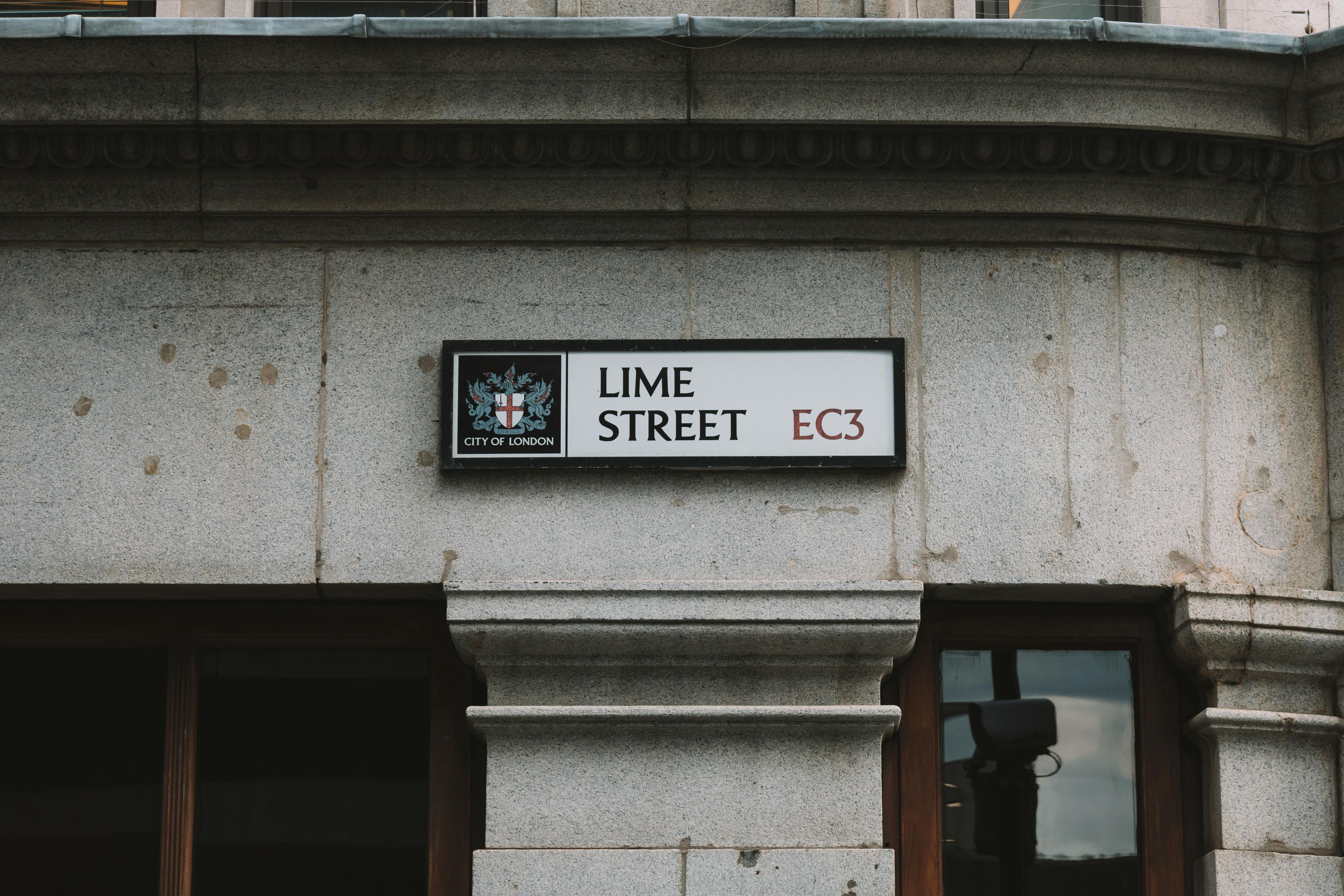 View of Lime Street sign on historic building facade in London, UK.