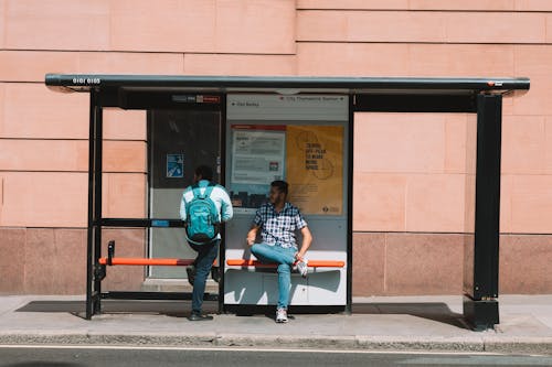 Men Waiting on Bus Stop in London