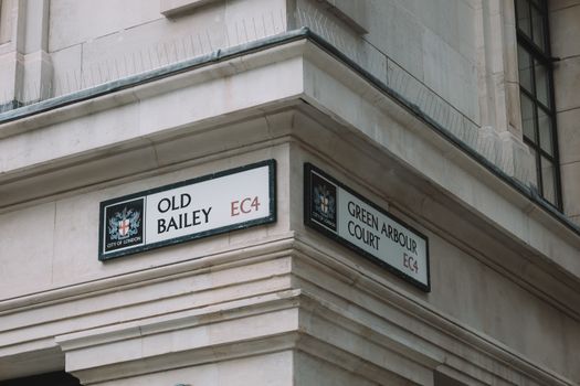 Closeup of a Townhouse Corner with a Street Name Signs