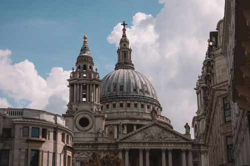 Free Iconic St Paul's Cathedral dome in London against a bright sky, showcasing historic architecture. Stock Photo