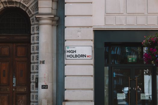 Elegant facade on High Holborn with classic architecture and street sign in Camden, London