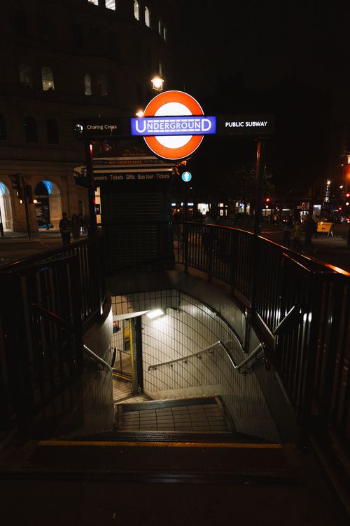 Free Entrance to Charing Cross London Underground station at night, vibrant urban atmosphere. Stock Photo