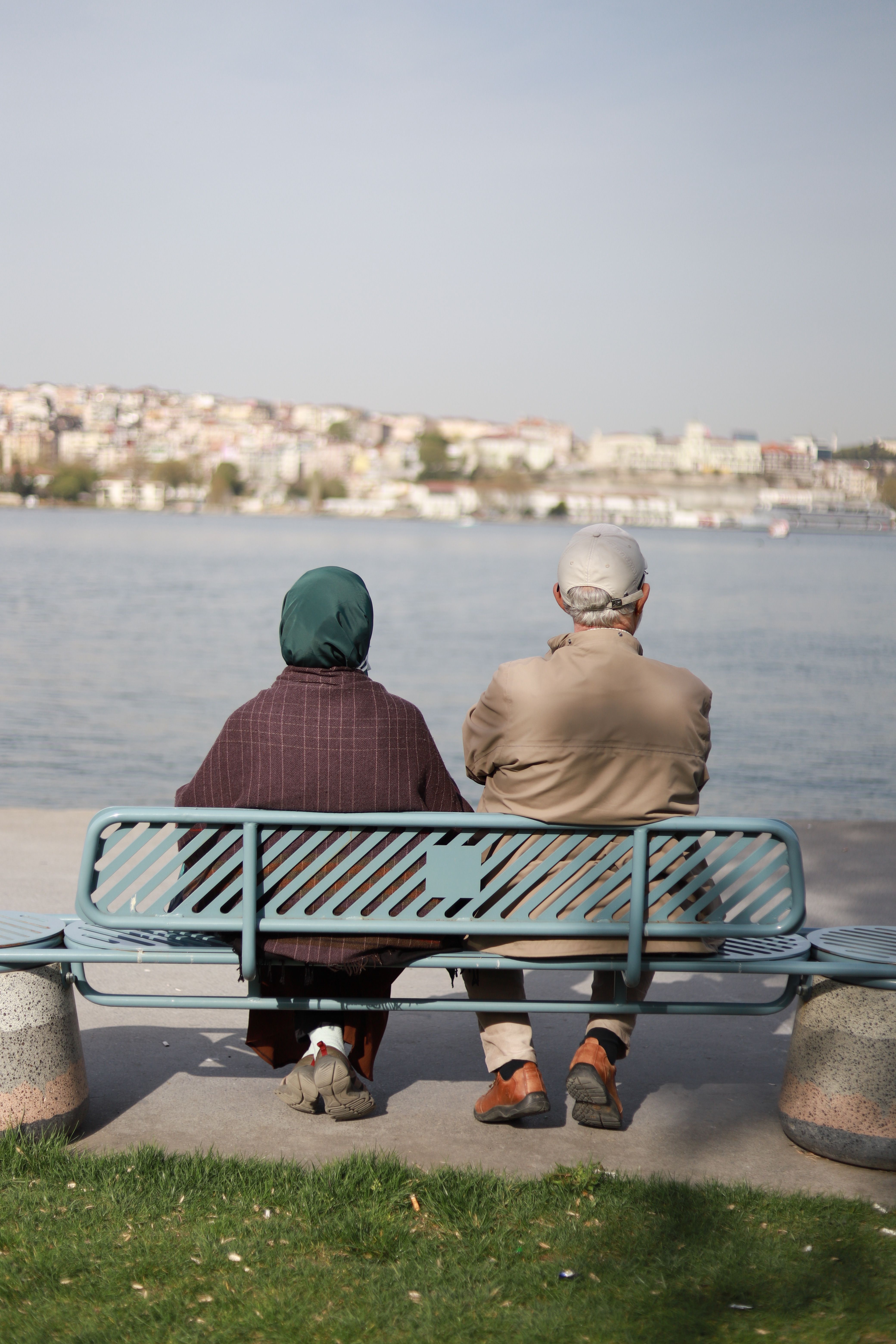 Elderly Couple Sitting on a Bench by the Lake · Free Stock Photo