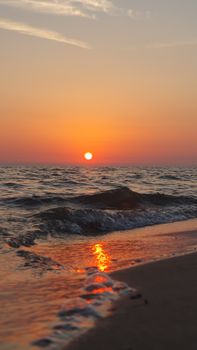 Beautiful sunset over waves on Viareggio beach, Toscana. Perfect serene seascape.