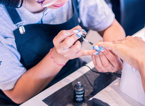 Woman Doing Her Nails at the Beauty Salon 