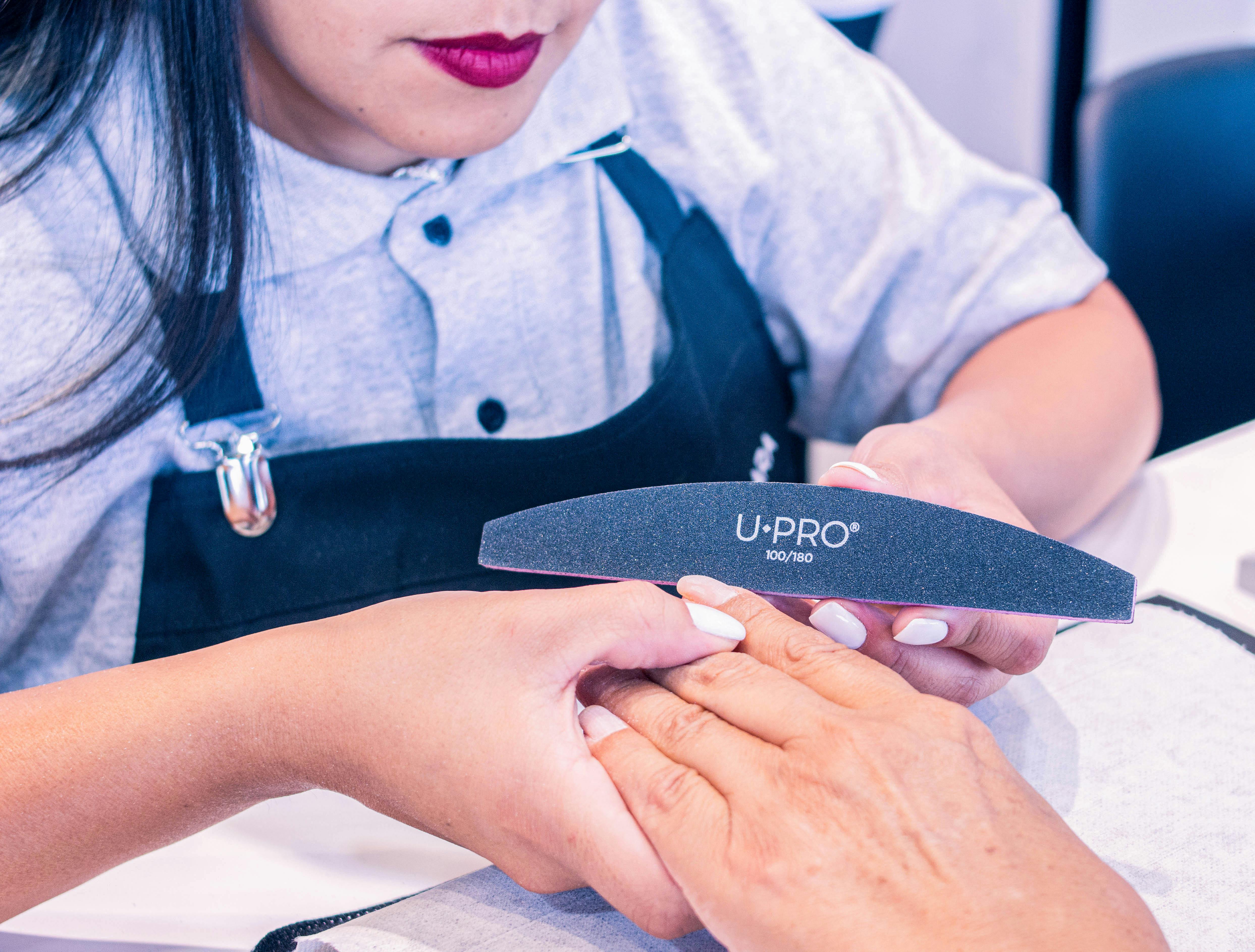 Nail technician at work in salon
