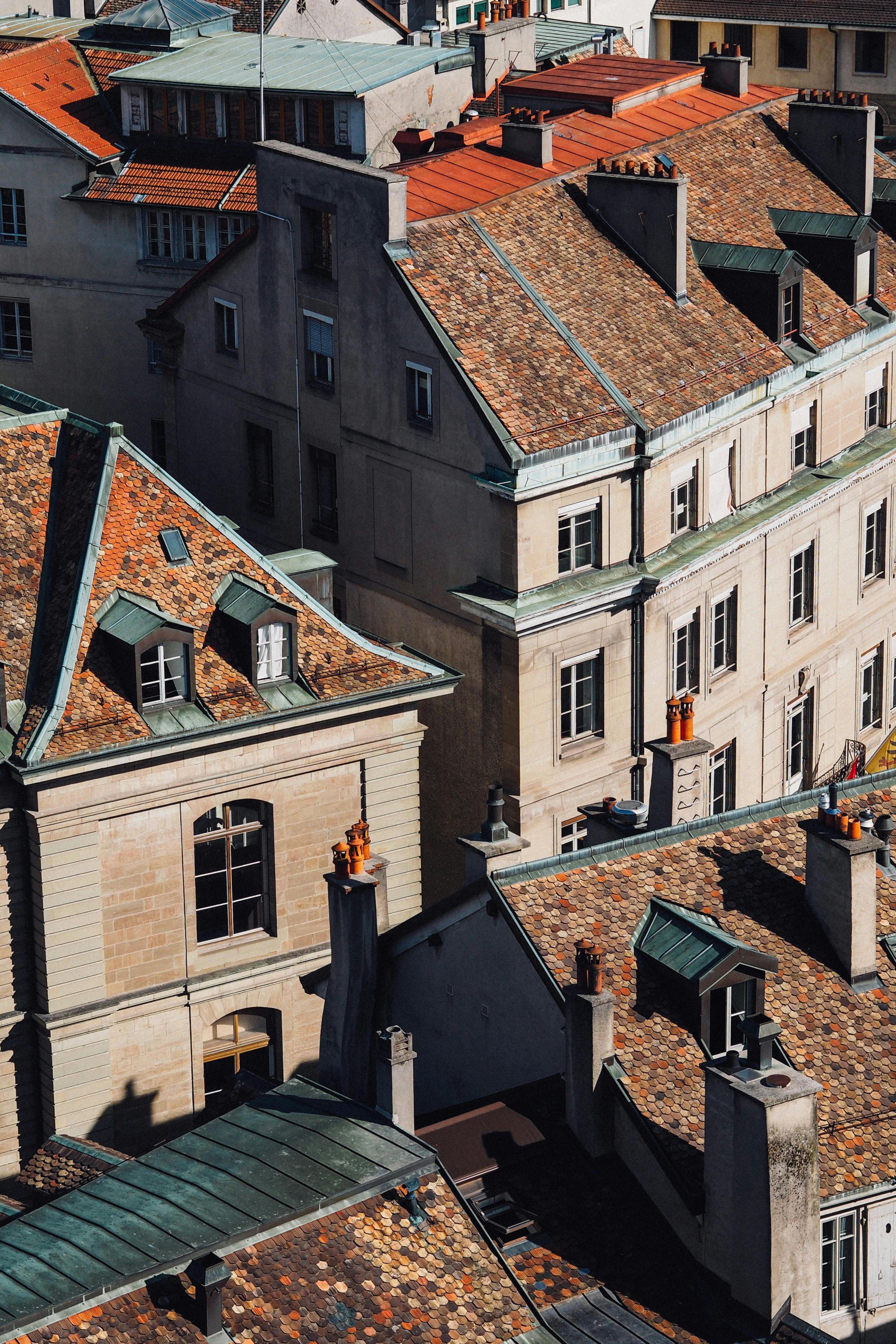 A sunny aerial view of classic European architecture featuring charming rooftops and historic buildings.