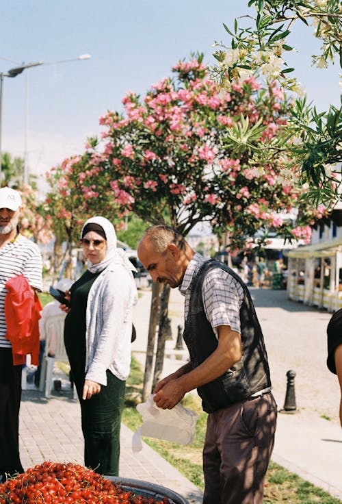 Street Vendor Selling Tomatoes to a Woman 