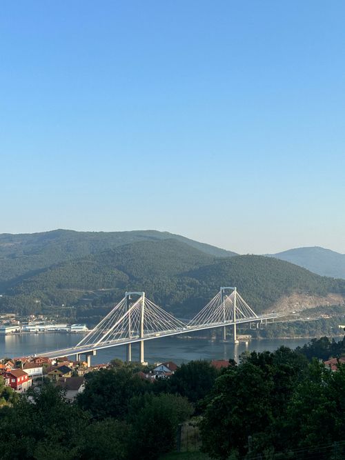 Free A panoramic view of Ponte de Rande in Vigo, Spain with lush hills and clear skies. Stock Photo