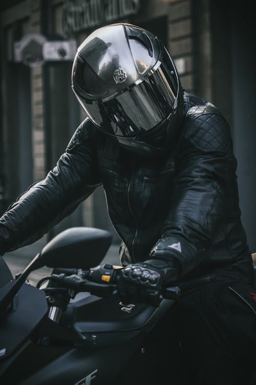Biker in Leather Jacket and Black Helmet