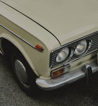 Close-up of a vintage car's headlights in Baku, creating a nostalgic feel.