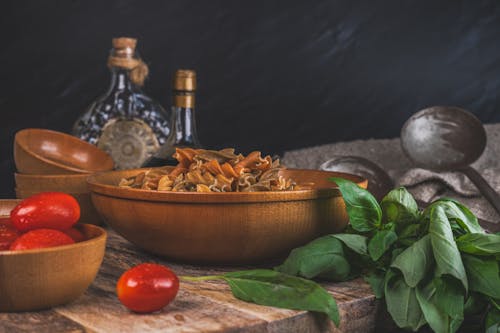 Pasta in Bowl by Basil on Table