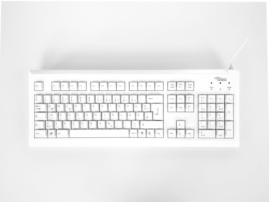White mechanical keyboard displayed against a white background, emphasizing minimalist design.