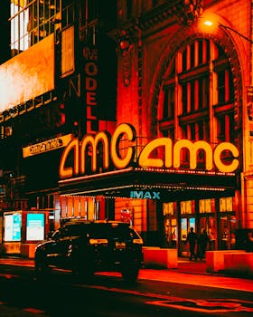 Colorful night scene of the AMC theater in New York City, capturing the iconic urban glow.