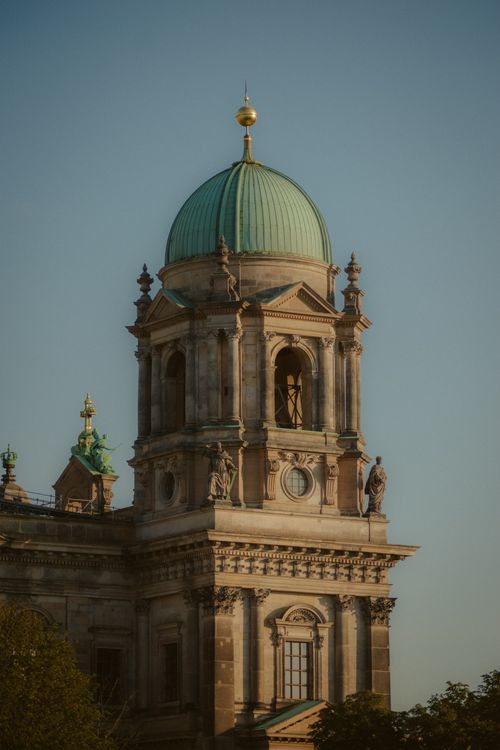 Free Close-up of the iconic Berlin Cathedral tower with a green dome against a clear sky. Stock Photo