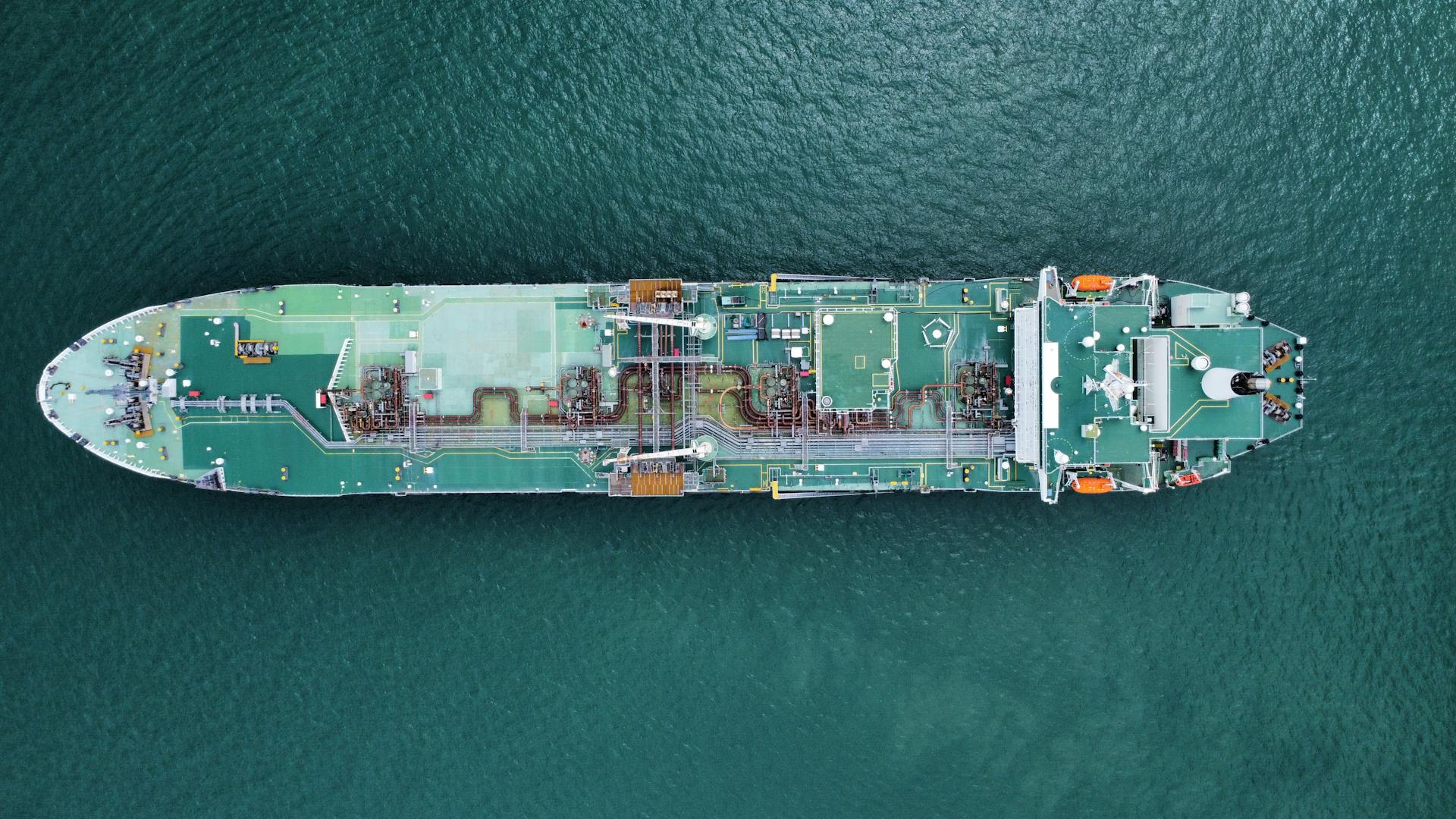 Aerial shot of a large tanker ship in calm ocean waters, showcasing its structure and design.