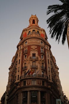 Ornate facade of Banco de Valencia at sunset illustrates Spain's architectural elegance.