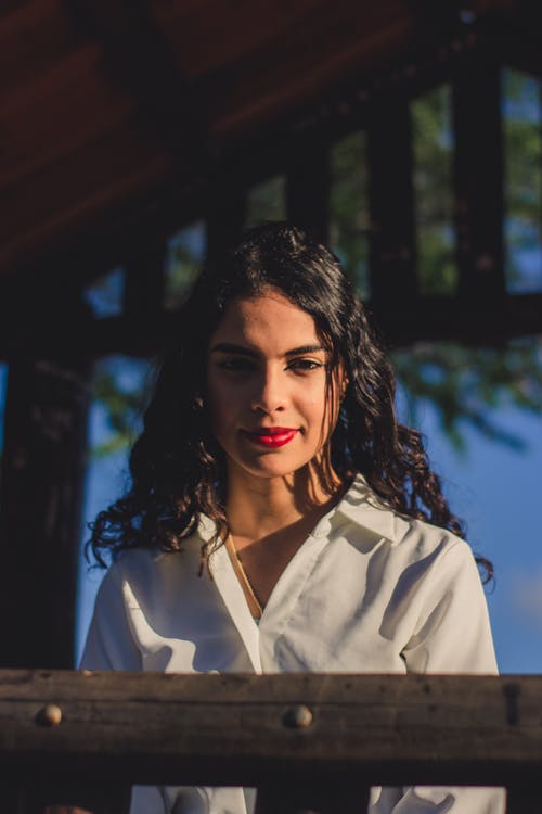 Young Woman Standing Outside in Sunlight 