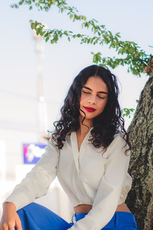 A Woman Sitting with her Eyes Closed