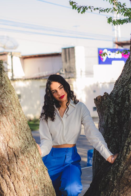 A Woman Standing by a Tree