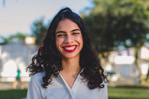 Portrait of a Young Brunette with Red Lips Smiling 