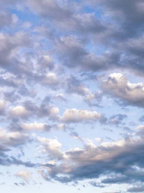 Free A serene sky filled with soft clouds, showcasing delicate pastel hues during the day. Stock Photo