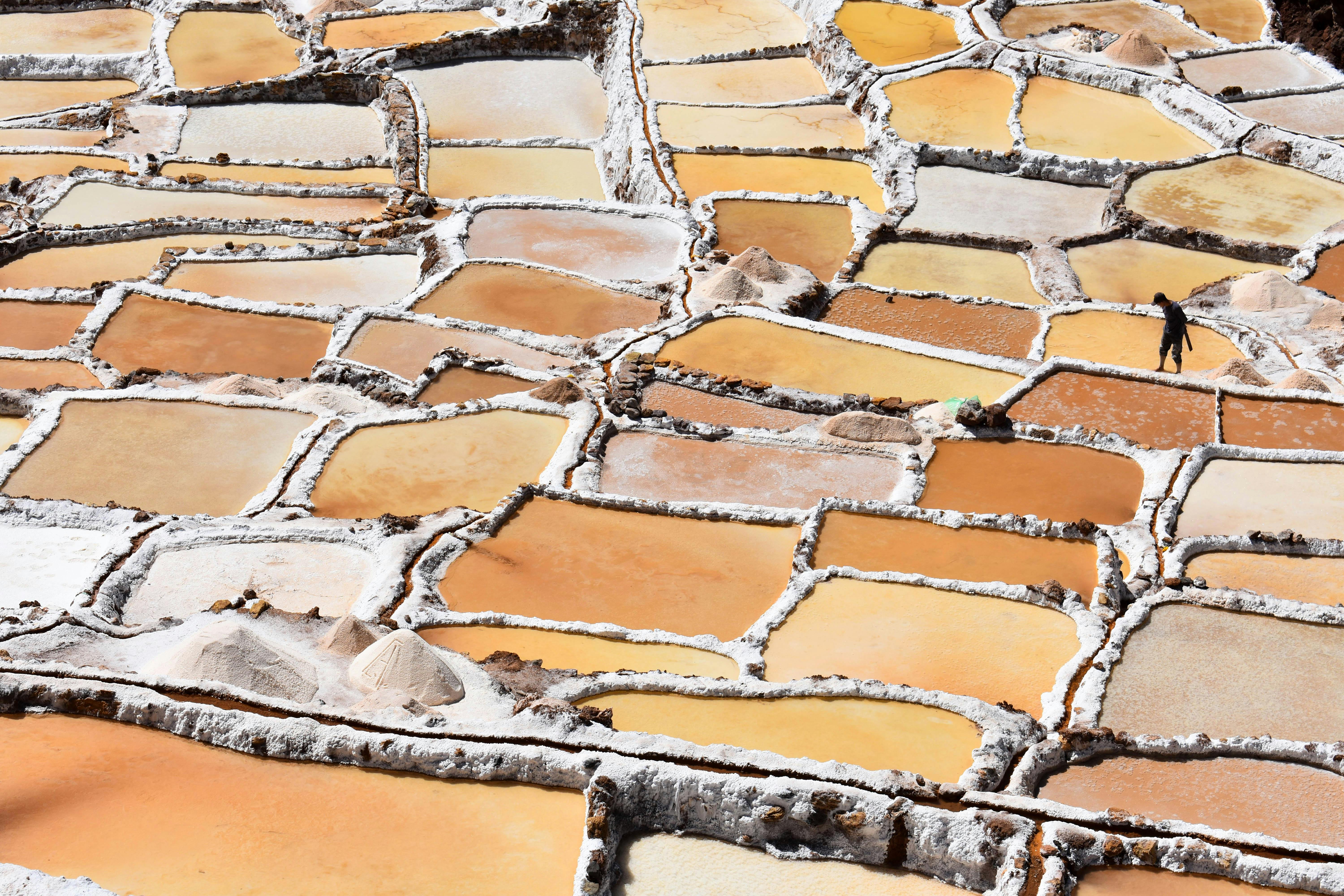 Explore the vibrant salt pans of Maras, Peru, showcasing traditional salt harvesting.