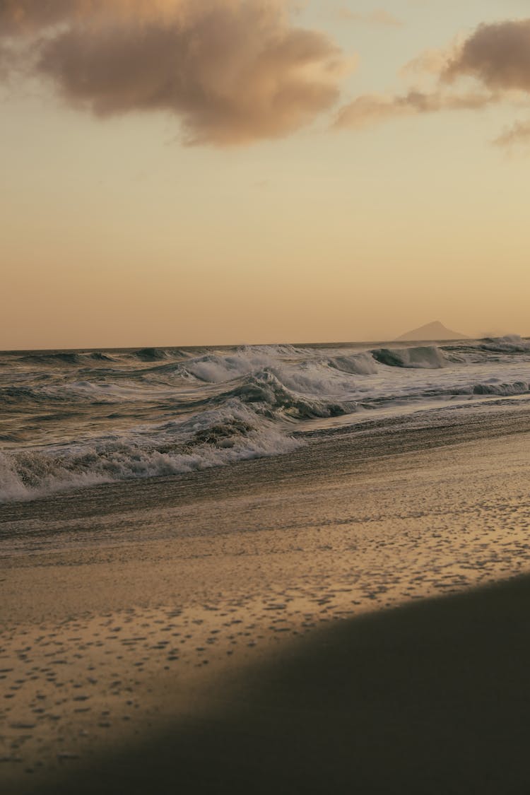 Waves On Beach At Sunset