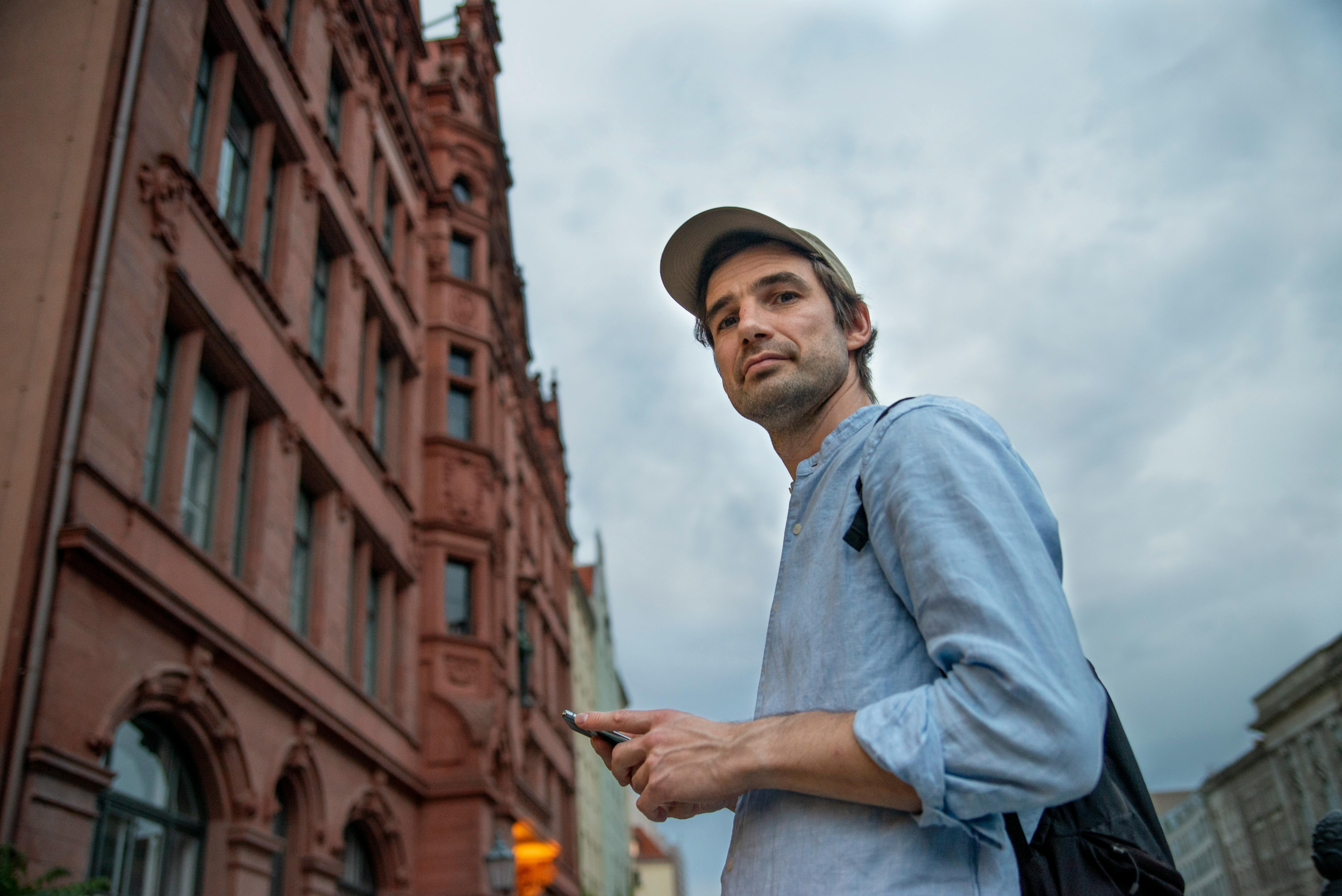 backpacker tourist holding smartphone city