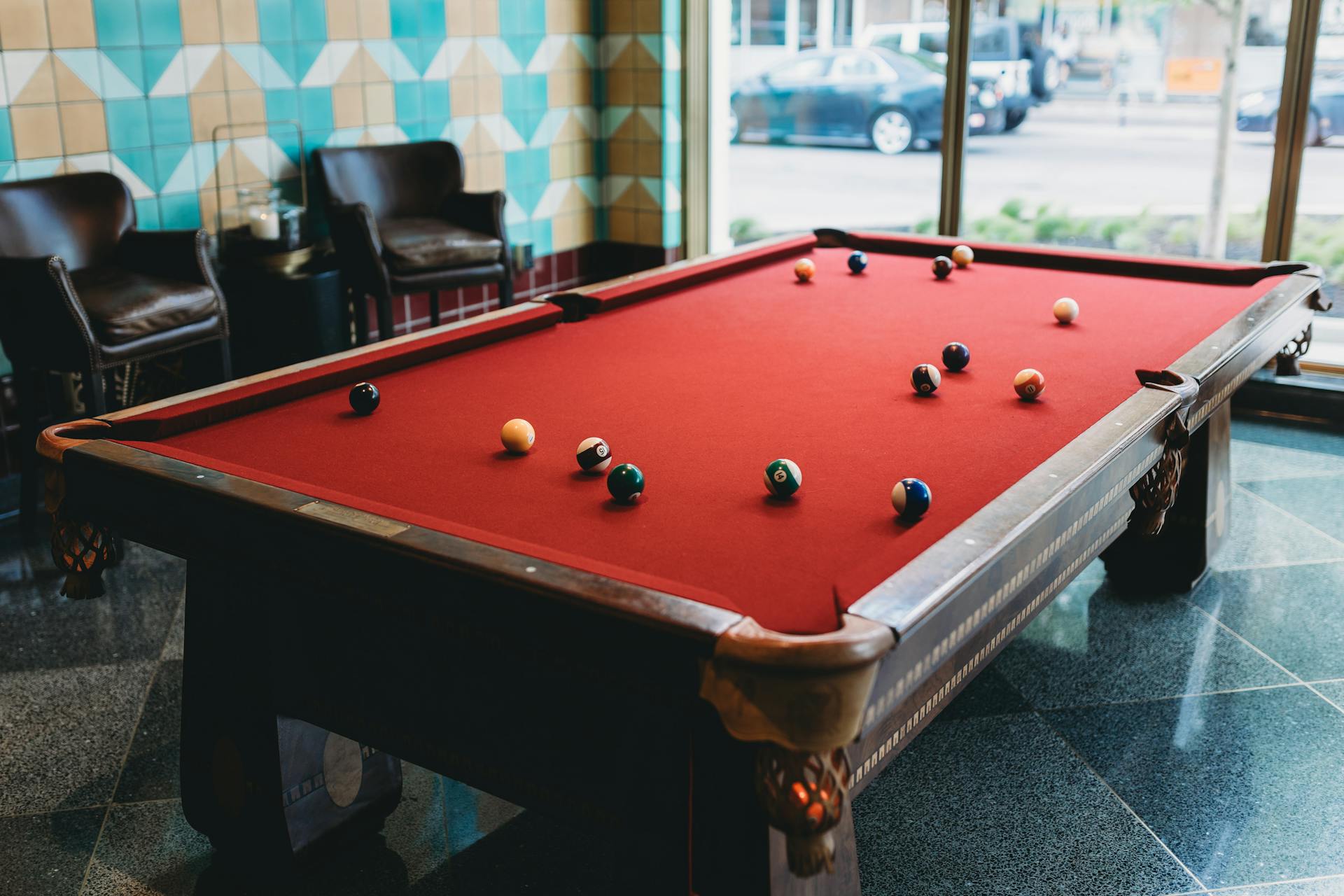 Elegant billiard table in a stylish hotel lobby in Indianapolis, offering a cozy setting for leisure.