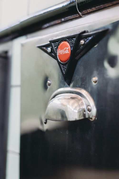Free Close-up shot of a vintage Coca-Cola dispenser in Indianapolis, showcasing a retro design. Stock Photo