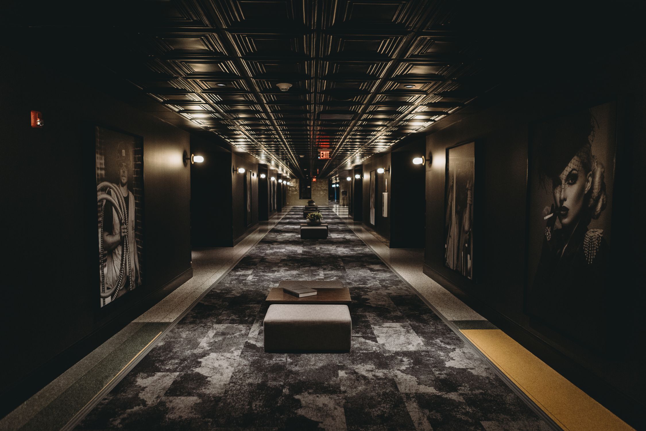 Stylish urban hotel corridor in Indianapolis showcasing modern art and design lighting.
