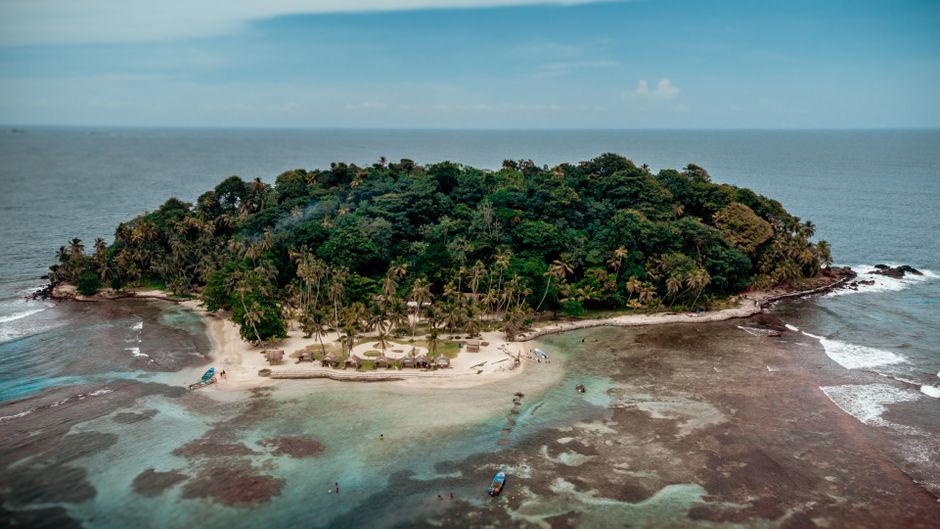 Pristine white sand beach with palm trees and turquoise water in the San Blas Islands, Panama