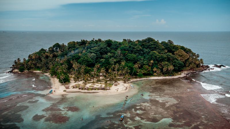 Aerial view of Isla Mamey, a small palm-covered island in the Caribbean Sea off Panama