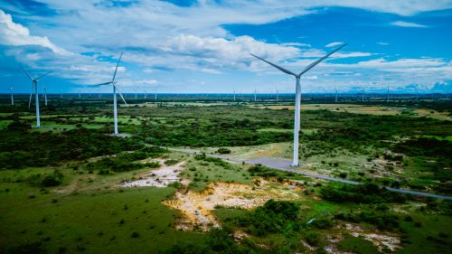 Free Aerial view of wind turbines on a vast green landscape in Coclé, Panama. Stock Photo